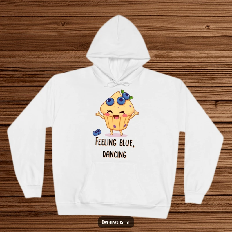 Funny hoodie featuring a winking muffin with blueberries, happily dancing, offering cozy warmth and a dose of delicious, whimsical humor.