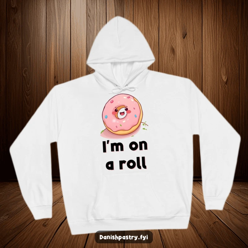 Funny donut joyfully rolling down a hill, cartoon graphic on a cozy hoodie, perfect for spreading laughter and warmth.