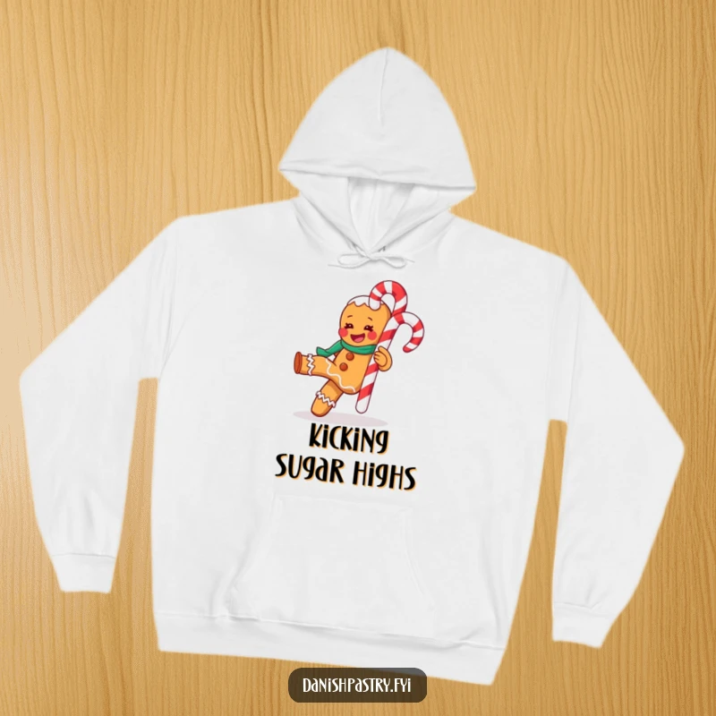 Funny hoodie design of a gleeful gingerbread man energetically kicking a large candy cane, perfect for cozy holiday wear.