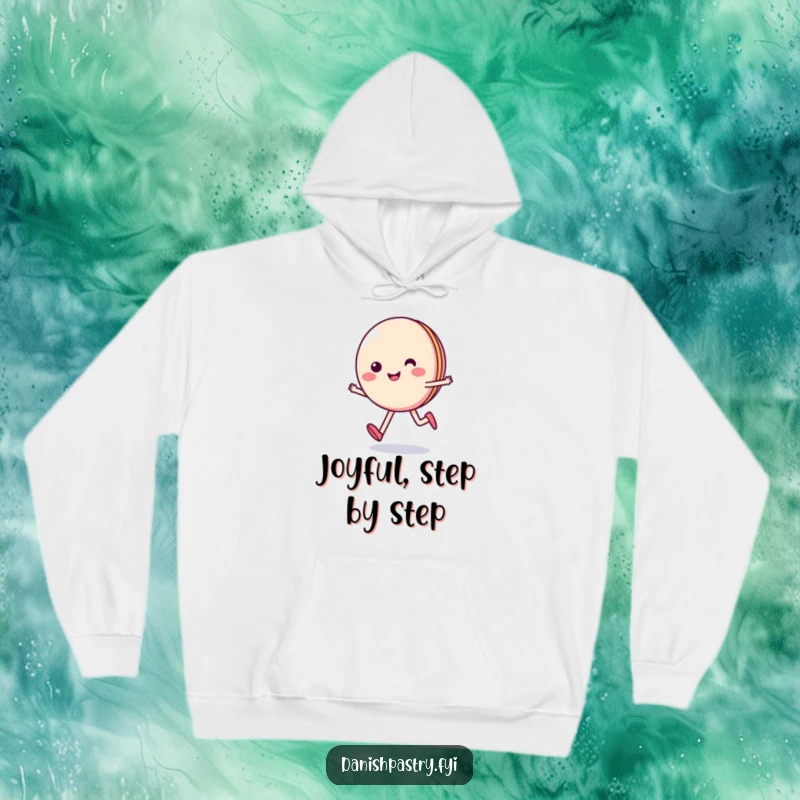 Funny hoodie featuring a smiling macaron character skipping happily, designed for warmth and spreading sweet, cheerful amusement.