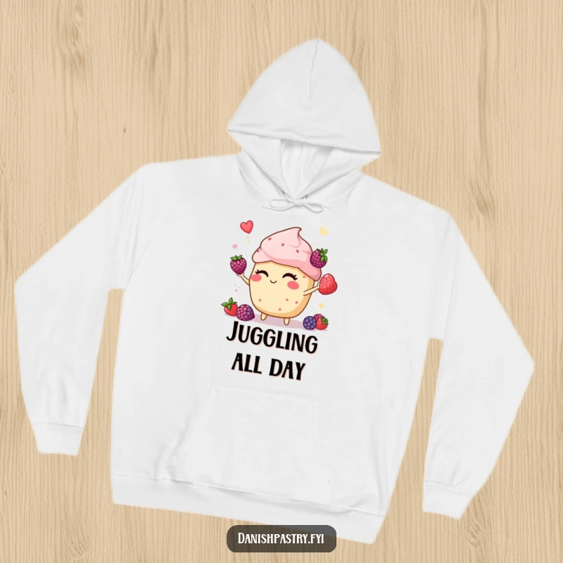 Funny muffin winking and juggling berries, depicted on a warm hoodie, perfect for staying cozy and spreading cheer.