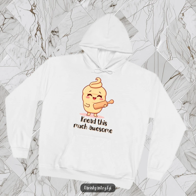 Funny Danish pastry character hoodie, cozily winking while holding a rolling pin, offering warmth and a dose of baking-related humor.