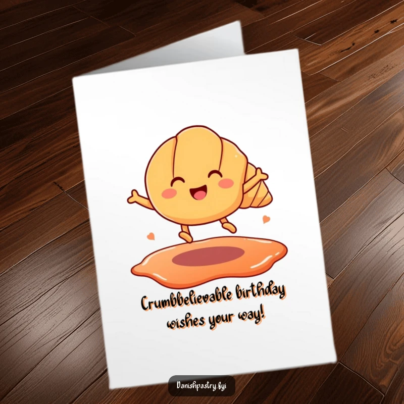 Funny free printable birthday card featuring a smiling croissant with legs leaping over a jam puddle, celebrating joyfully.