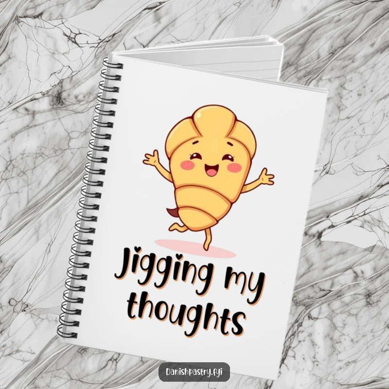 Funny almond croissant character notebook, doing a happy jig, ideal for writing down happy thoughts, recipes, or creative dance inspirations.