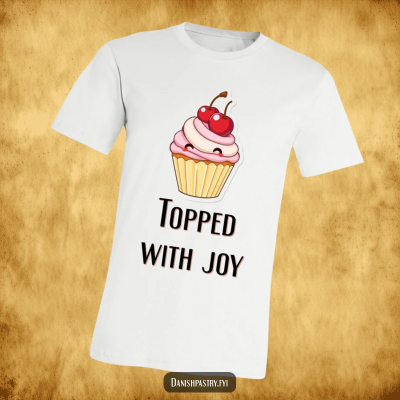 Funny cupcake with frosting happily bouncing a large cherry, a whimsical and sweet t-shirt graphic.